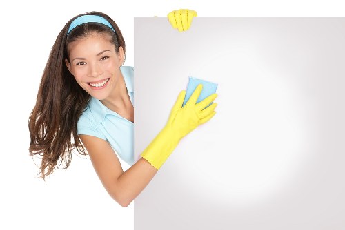 Cleaning team working safely with protective equipment in a home